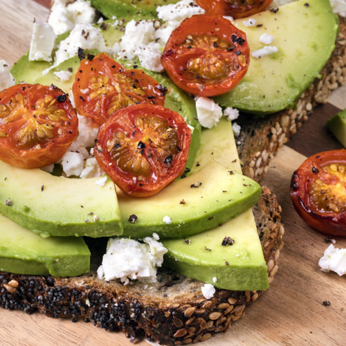 Avocado toast with roasted peppers and cheese crumbles