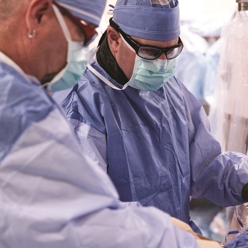 Two interventional cardiologists perform an operation in the OR