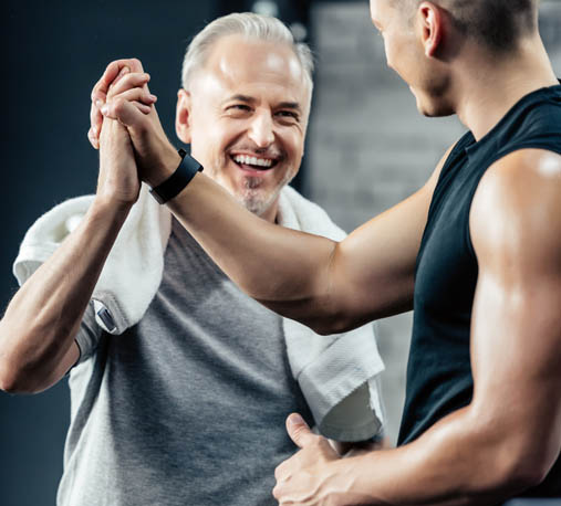 Two men in the gym high five